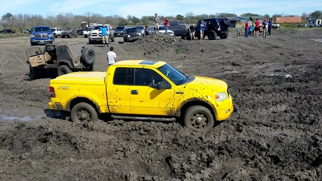 Ford F-150 in mud pit with crowd watching at 281 Country Club