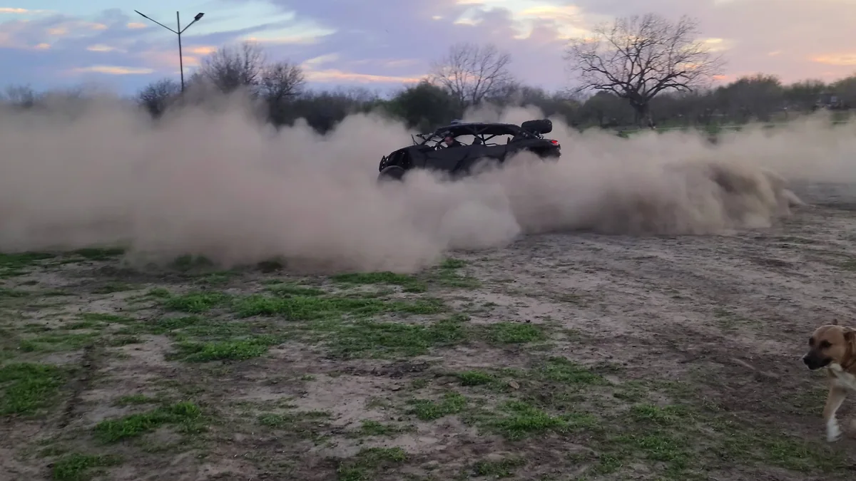 Can-Am UTV throwing a dust cloud burnout at 281 Country Club San Antonio