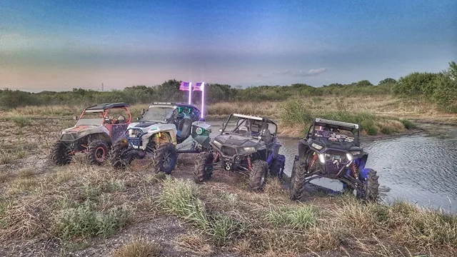 Four UTVs with LED lights near the pond at dusk at 281 CC San Antonio