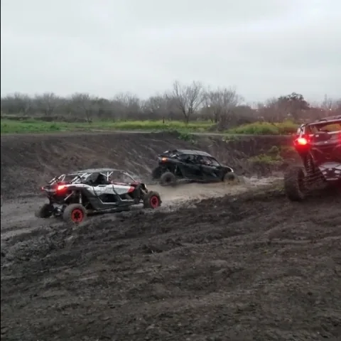 Three Can-Am UTVs on a rainy trail at 281 CC offroad San Antonio TX