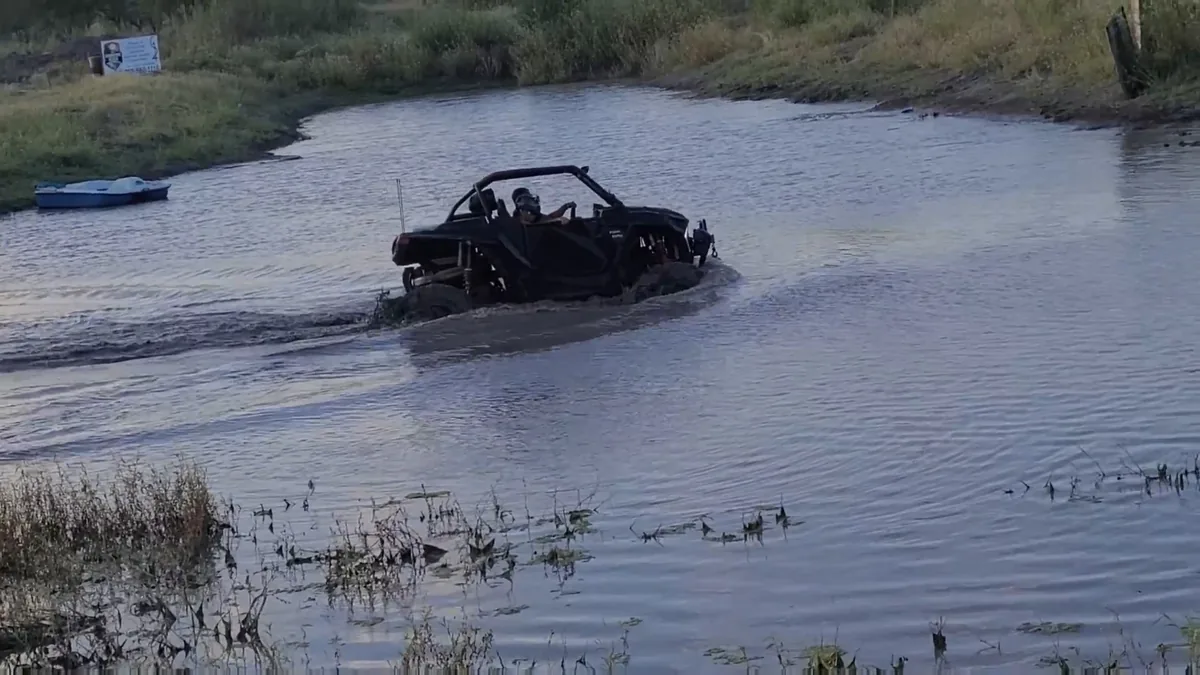 Black Can-Am UTV deep in pond water crossing at 281 CC offroad park