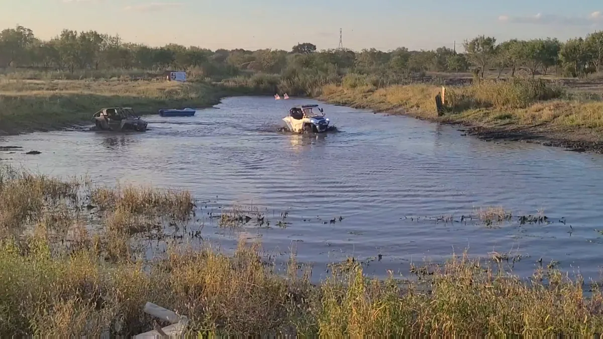 Two UTVs crossing the pond at golden hour at 281 Country Club San Antonio TX