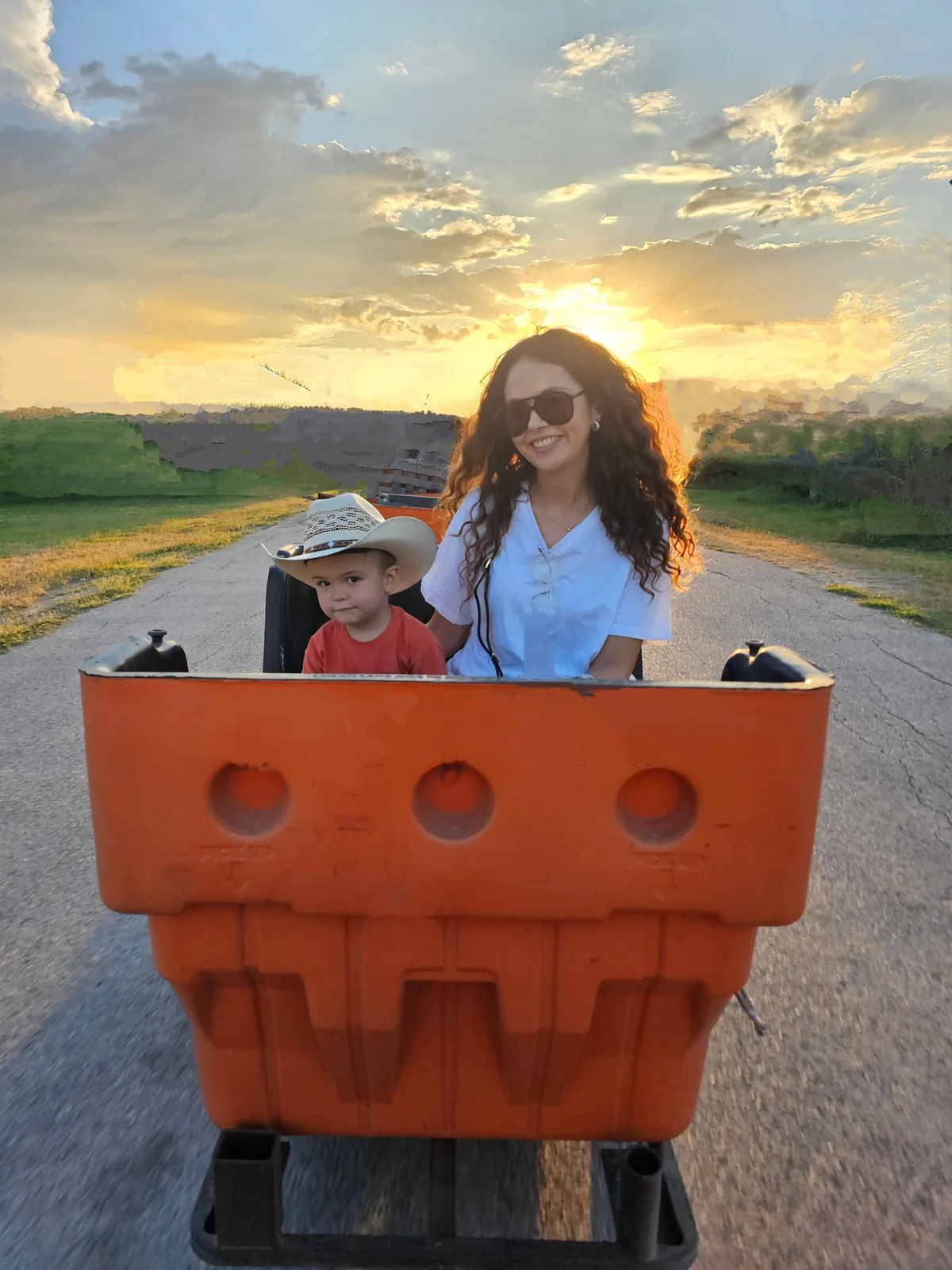Mother and small child riding in a train cart at sunset at 281 Country Club