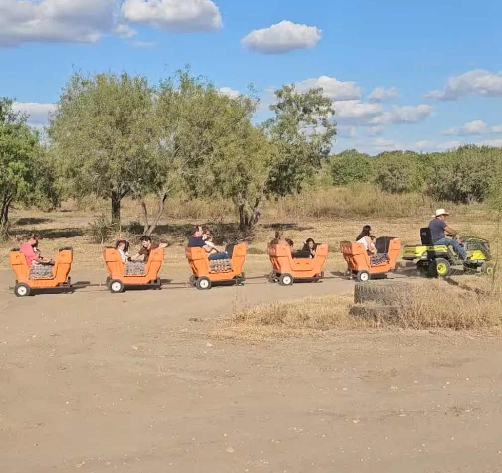 Families riding the kids train carts at 281 Country Club in San Antonio TX