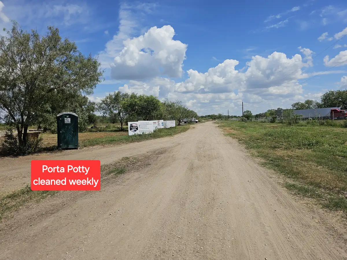 Storage lot entrance road with porta-potty at 281 Country Club San Antonio TX